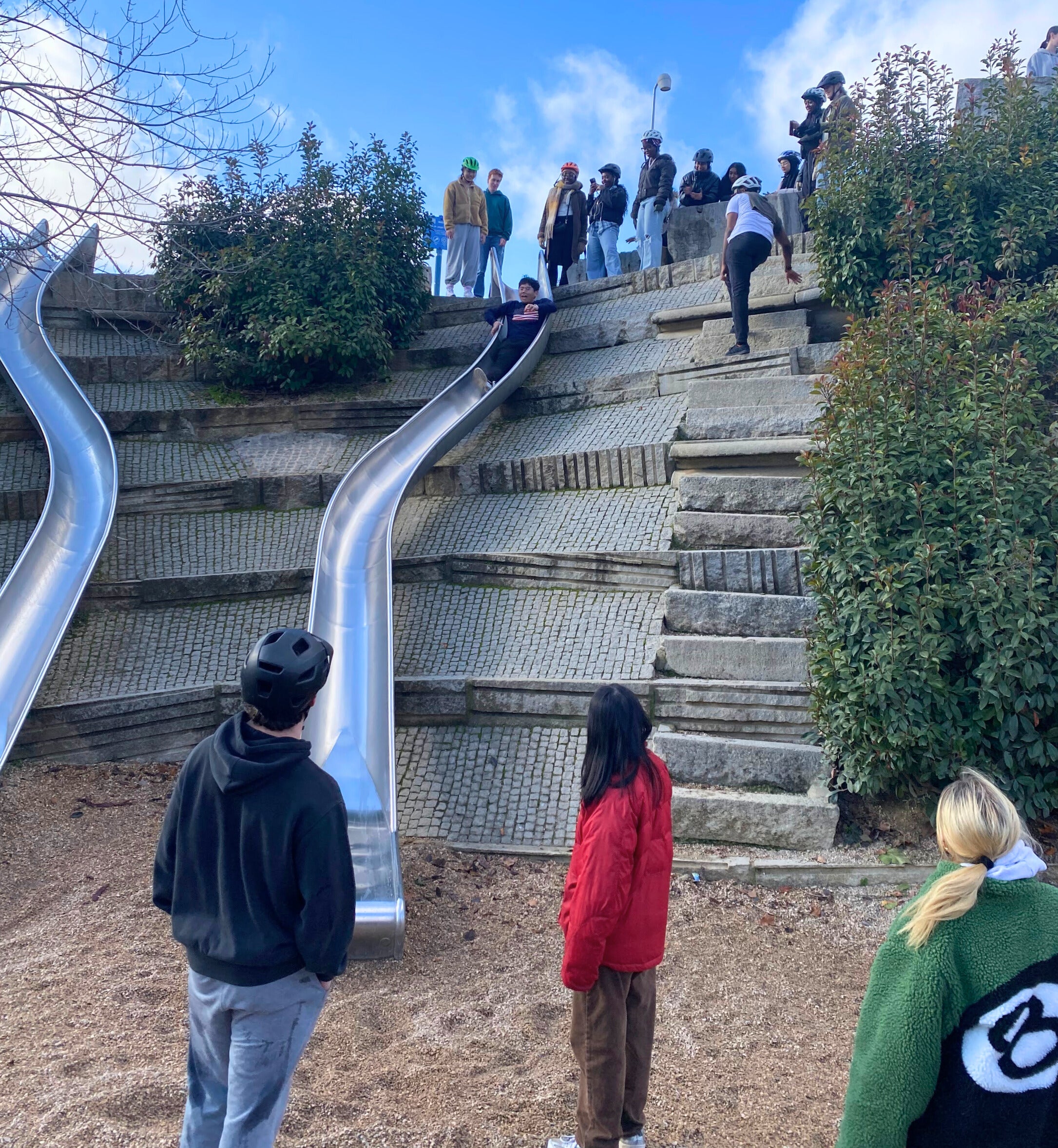 Students taking a pit stop to go down slides.