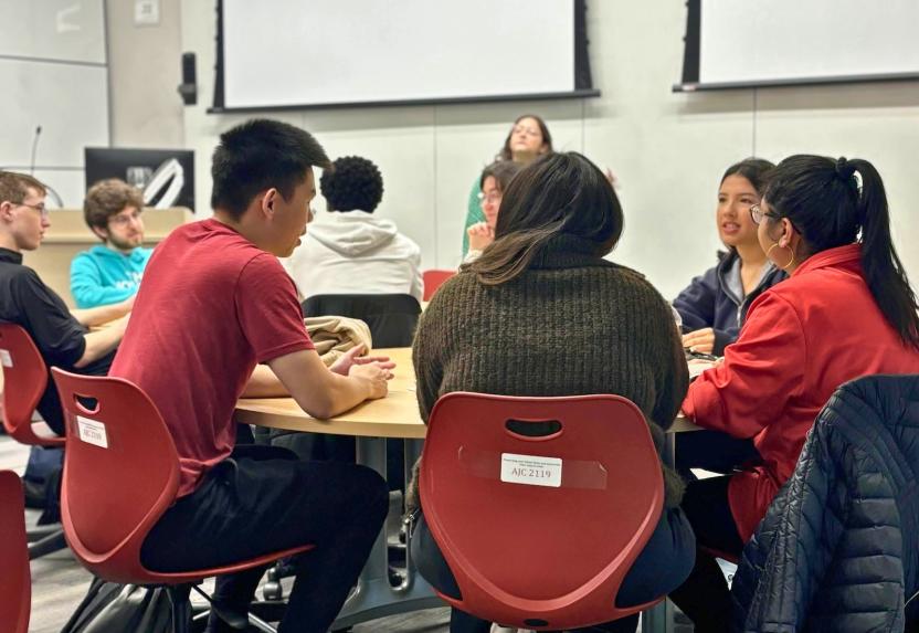 Students sitting at a round table talking