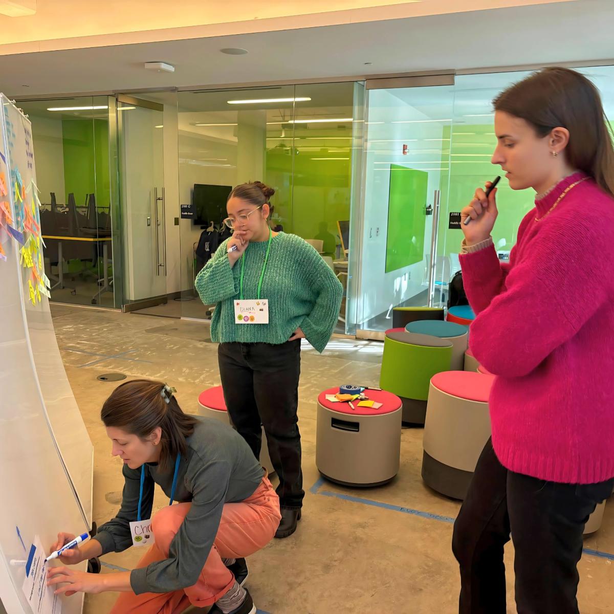 Christine Alexander (left), Diana Rivera (center), and Anne Zappas (right) brainstorming HMW during AIE 10(+1) Year Unconventional Convention in October