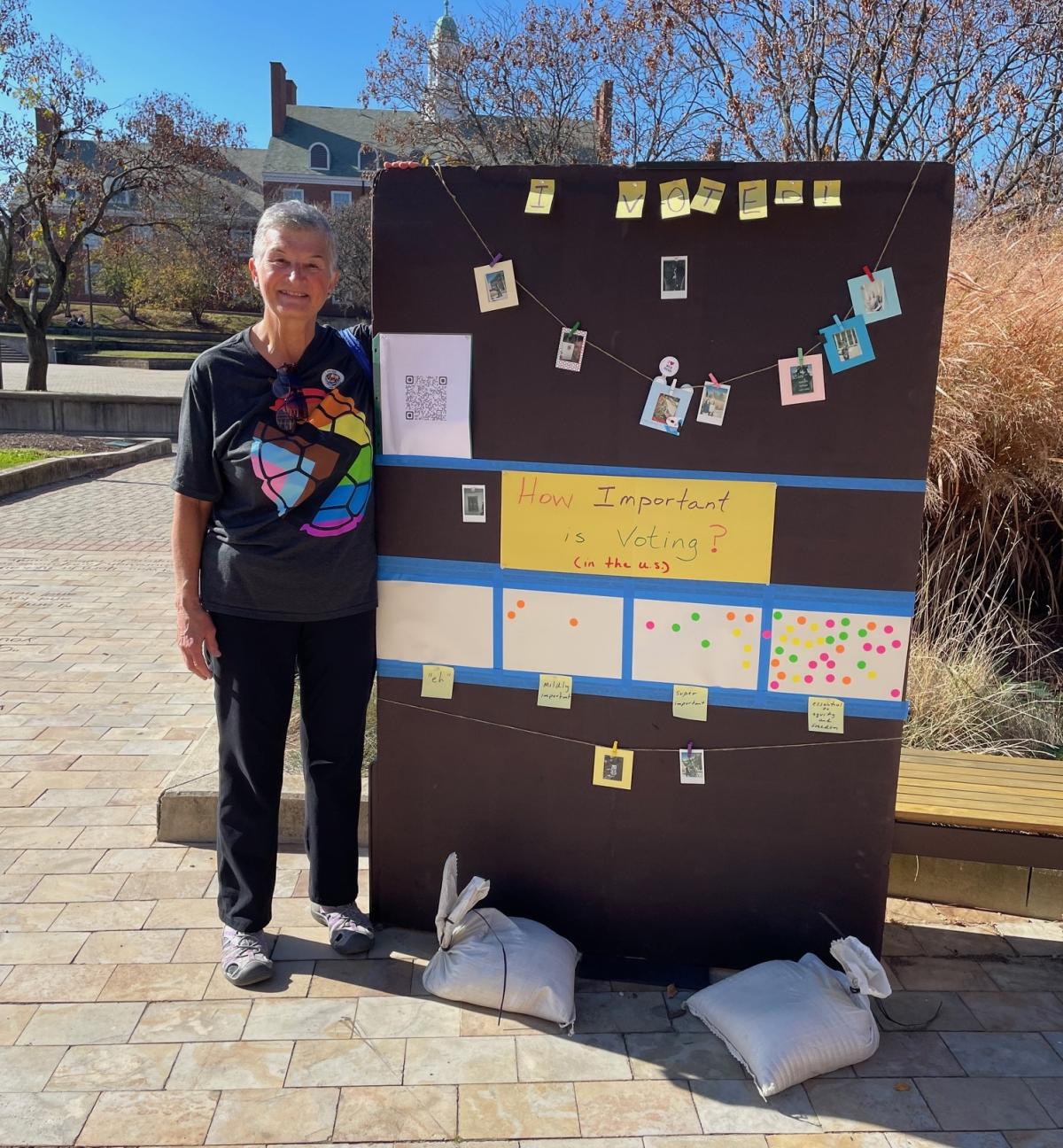 Teresa standing beside her "Importance of Voting" board