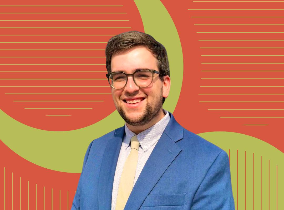 Picture of Clark Mitchell in blue suit and light yellow tie with an artistic green and orange background