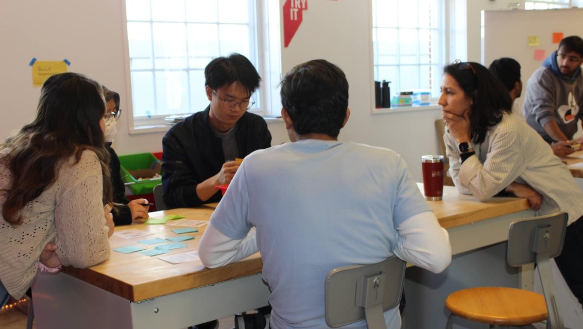 Four people sitting at a table deep in discussion