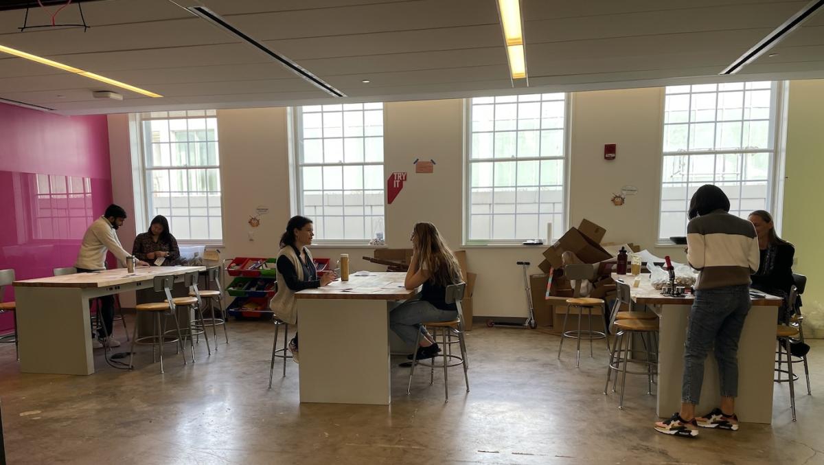 People sitting in pairs at tables talking