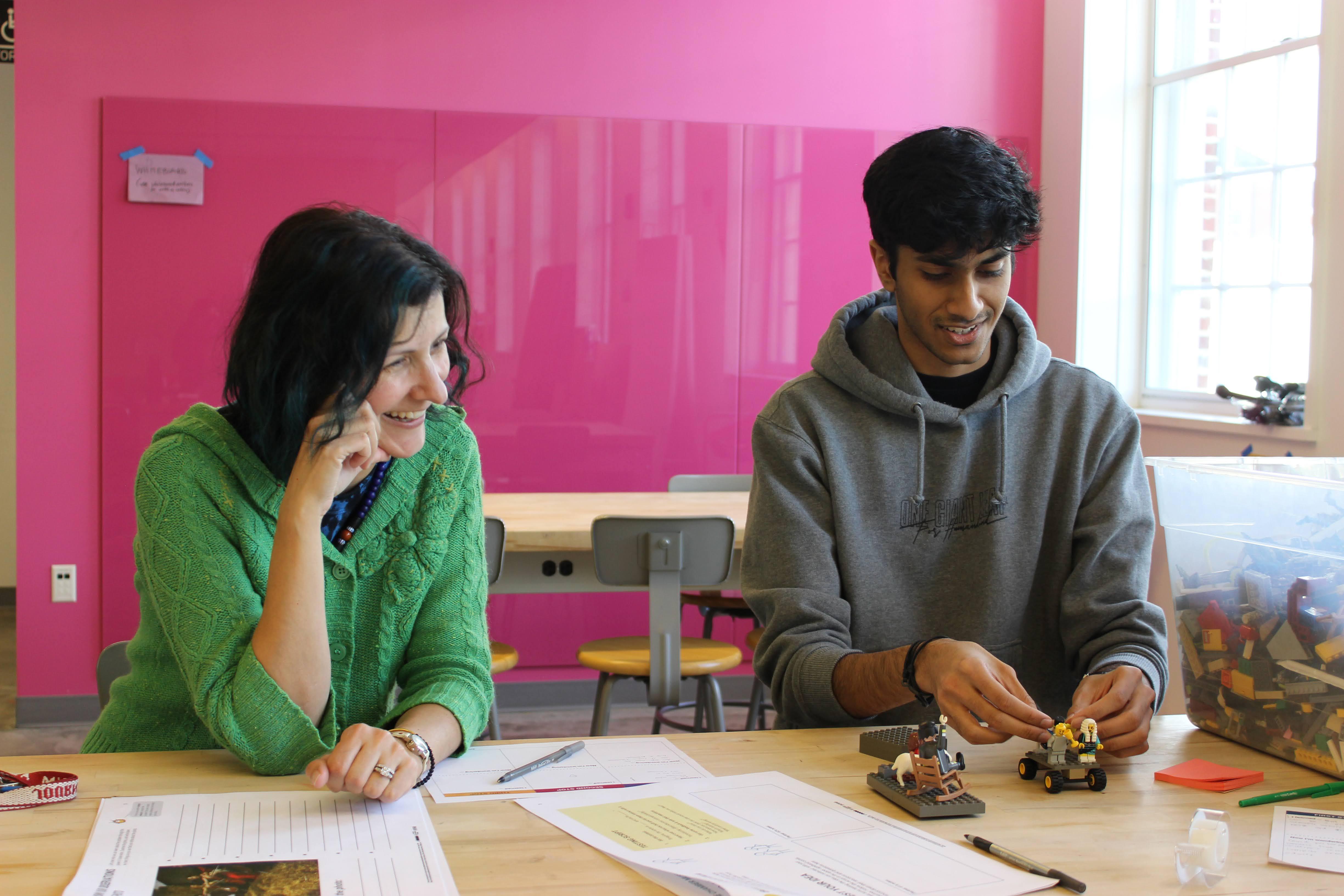 AIE Team member, Mira Azarm, works 1 on 1 with a student