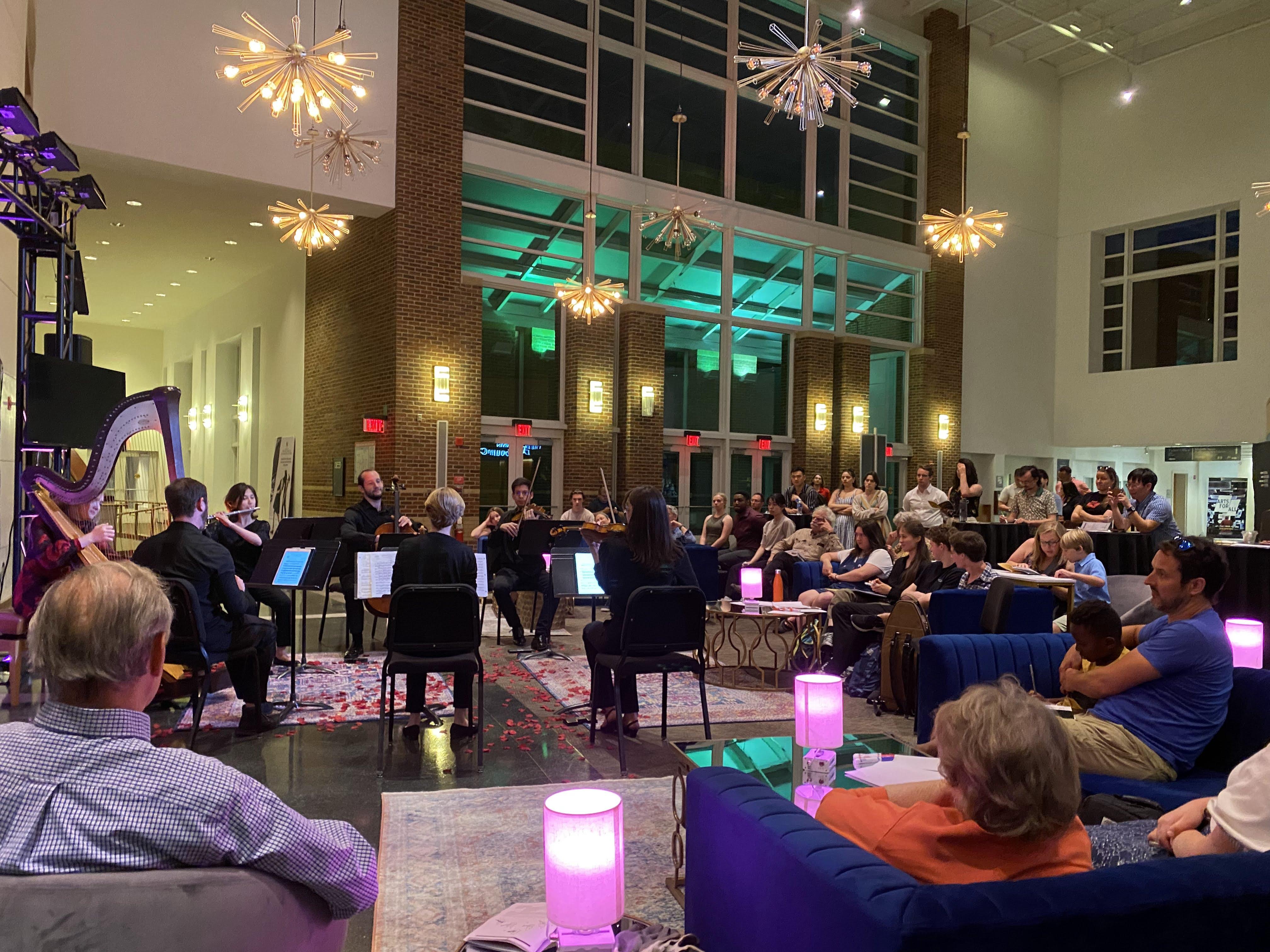 Small orchestra playing in lobby of building