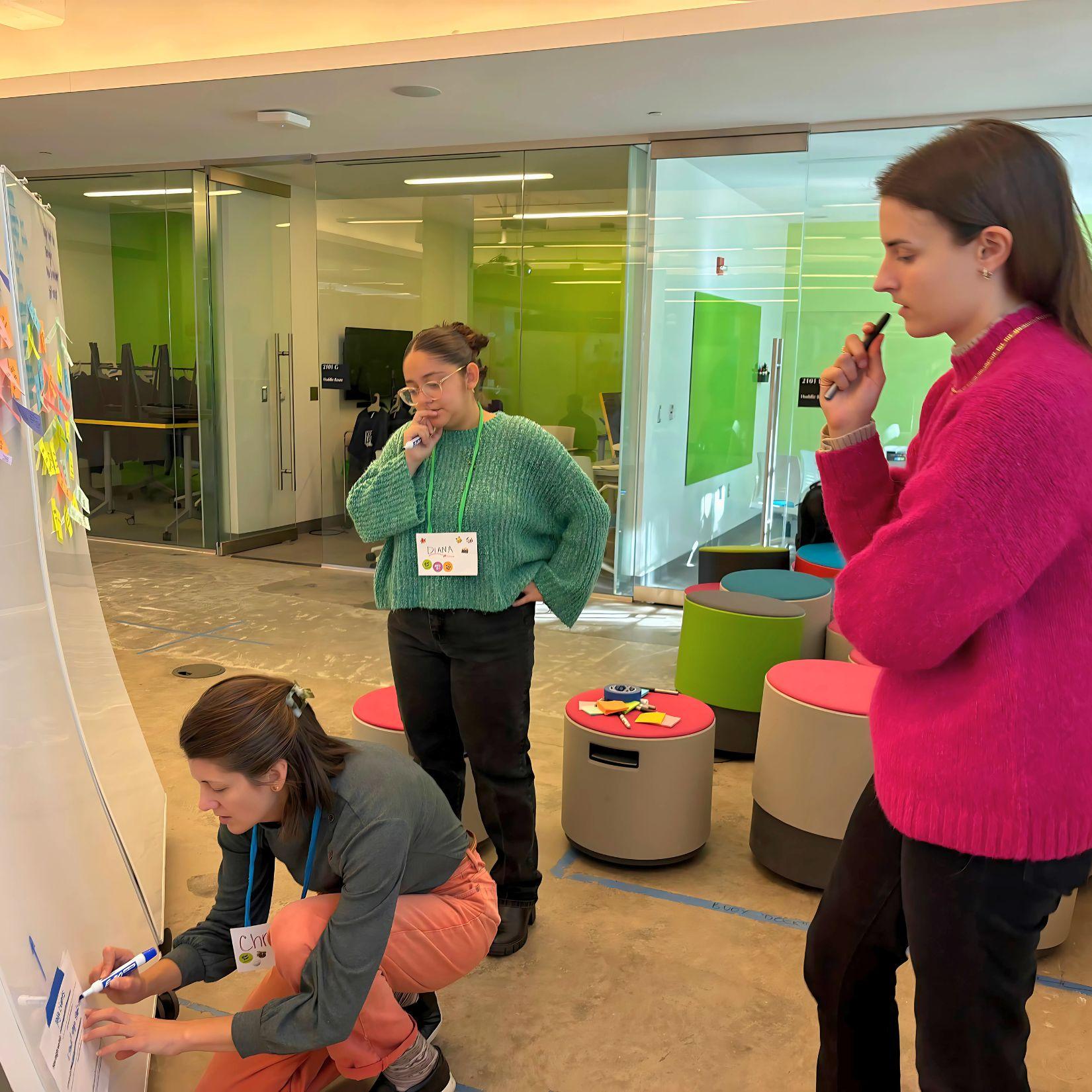 Christine Alexander (left), Diana Rivera (center), and Anne Zappas (right) brainstorming HMW during AIE 10(+1) Year Unconventional Convention in October