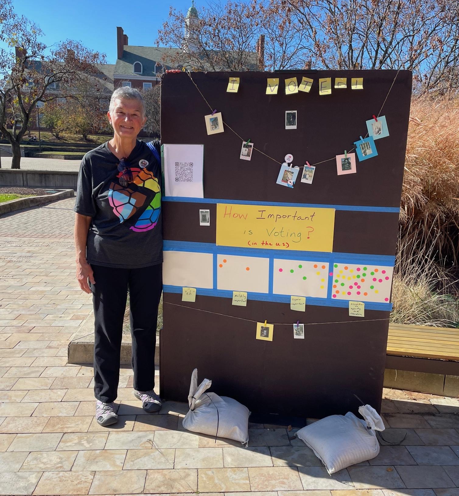 Teresa standing beside her "Importance of Voting" board