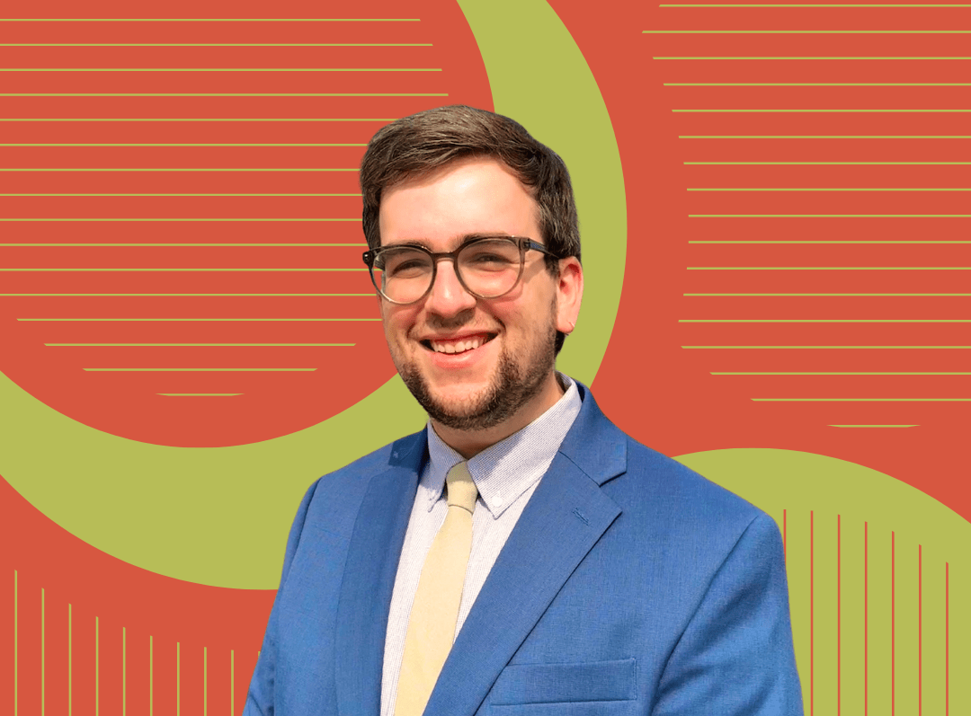 Picture of Clark Mitchell in blue suit and light yellow tie with an artistic green and orange background